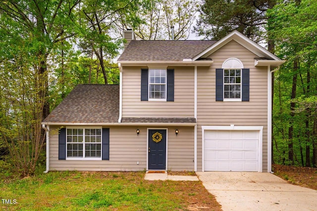 traditional home with an attached garage, a chimney, concrete driveway, and roof with shingles