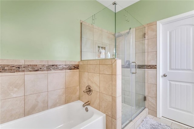 full bath featuring a shower stall and a bathtub