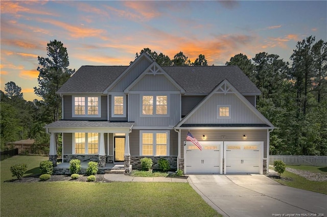99 Wildlife Bridge Ct, Spring Lake, NC 28390 - view of front of property featuring a porch, a front yard, fence, concrete driveway, and stone siding