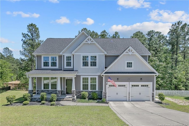 99 Wildlife Bridge Ct, Spring Lake, NC 28390 - craftsman-style home featuring covered porch, driveway, a garage, fence, and a front lawn