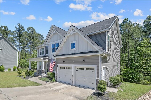 99 Wildlife Bridge Ct, Spring Lake, NC 28390 - view of front of home with roof with shingles, a garage, board and batten siding, a front yard, and driveway