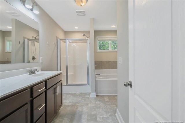 99 Wildlife Bridge Ct, Spring Lake, NC 28390 - bathroom featuring a bath, visible vents, a stall shower, vanity, and baseboards