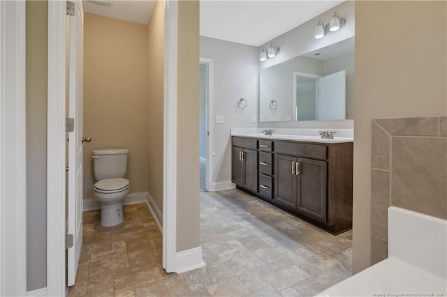 99 Wildlife Bridge Ct, Spring Lake, NC 28390 - full bath with a sink, double vanity, toilet, baseboards, and stone finish flooring