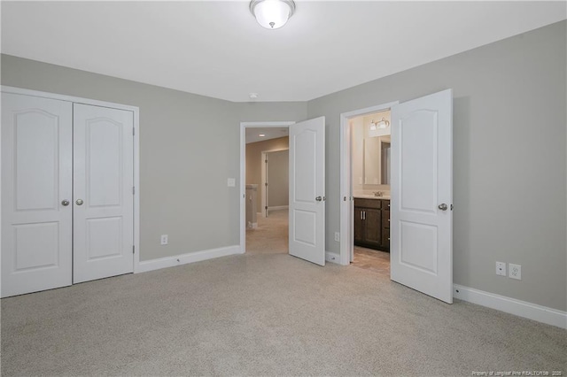 99 Wildlife Bridge Ct, Spring Lake, NC 28390 - unfurnished bedroom with baseboards, ensuite bathroom, a closet, and light colored carpet