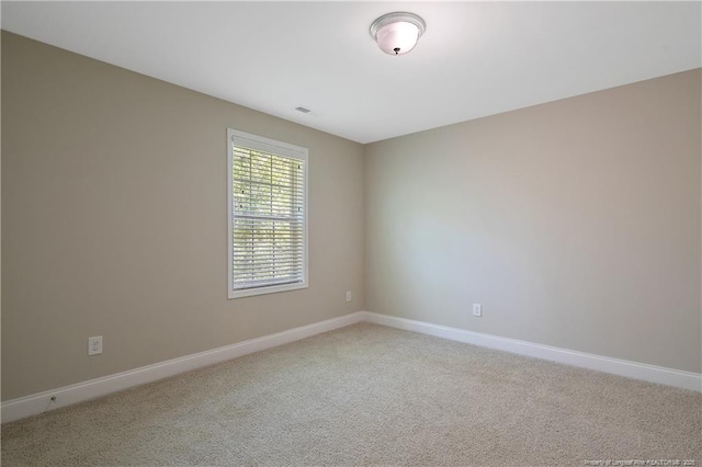 99 Wildlife Bridge Ct, Spring Lake, NC 28390 - spare room with baseboards and light colored carpet