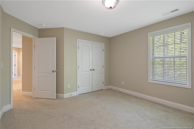 99 Wildlife Bridge Ct, Spring Lake, NC 28390 - unfurnished bedroom with baseboards, visible vents, carpet, and a closet