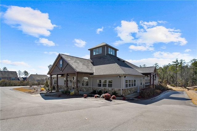 99 Wildlife Bridge Ct, Spring Lake, NC 28390 - exterior space with roof with shingles, covered porch, and stone siding