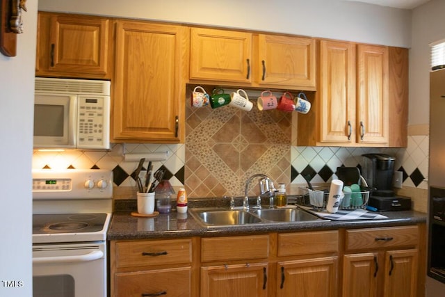 kitchen with backsplash, brown cabinetry, a sink, and white appliances