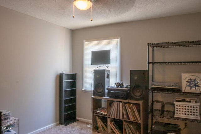 misc room with baseboards and carpet flooring