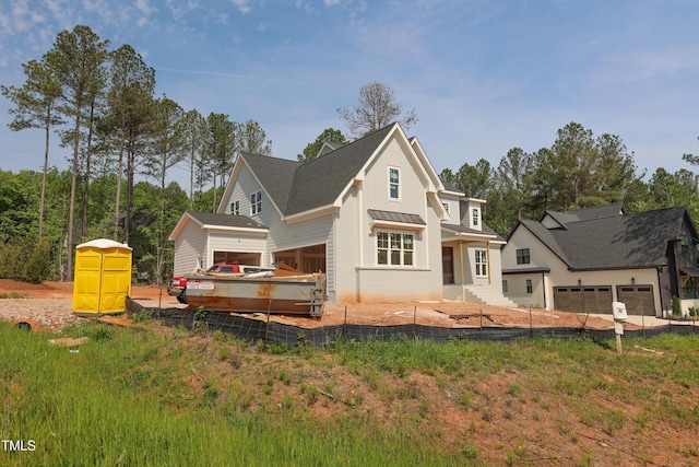 rear view of property featuring board and batten siding, metal roof, a standing seam roof, and fence