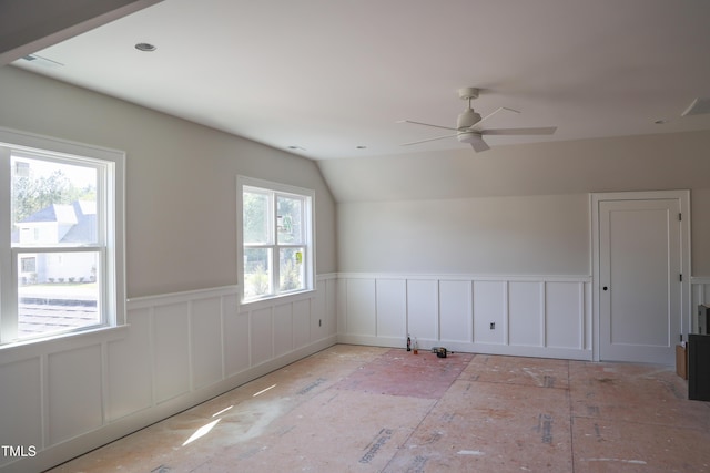 7301 Wexford Woods Ln, Wake Forest, NC 27587 - spare room with a wainscoted wall, ceiling fan, and vaulted ceiling