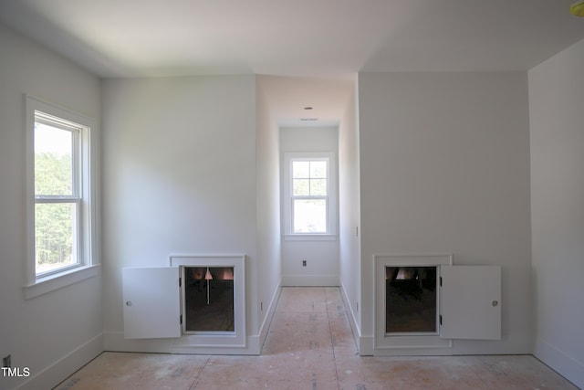 7301 Wexford Woods Ln, Wake Forest, NC 27587 - unfurnished living room with baseboards and a fireplace