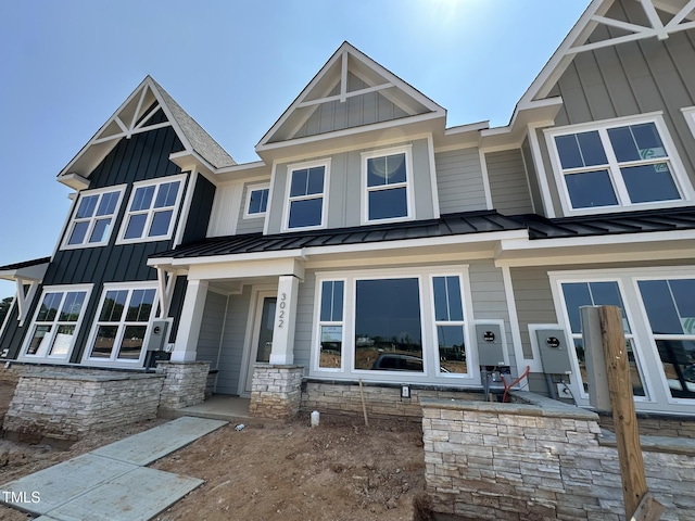 3022 White Rail Dr, Fuquay Varina, NC 27526 - view of front of home with a standing seam roof, a metal roof, board and batten siding, and stone siding