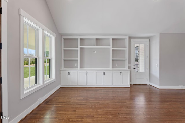 unfurnished living room with baseboards, dark wood finished floors, and lofted ceiling