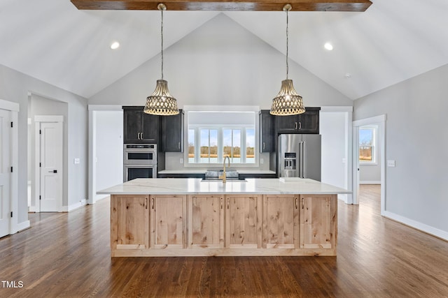 kitchen featuring a large island with sink, dark wood-style flooring, baseboards, high vaulted ceiling, and appliances with stainless steel finishes
