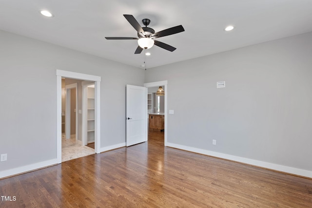 unfurnished bedroom featuring baseboards, a ceiling fan, wood finished floors, and recessed lighting