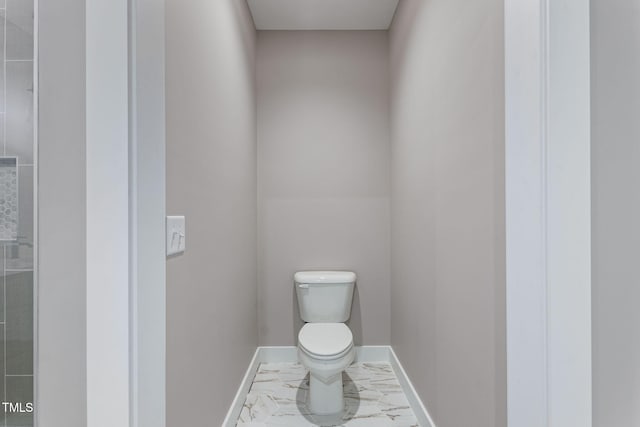 bathroom with marble finish floor, toilet, and baseboards