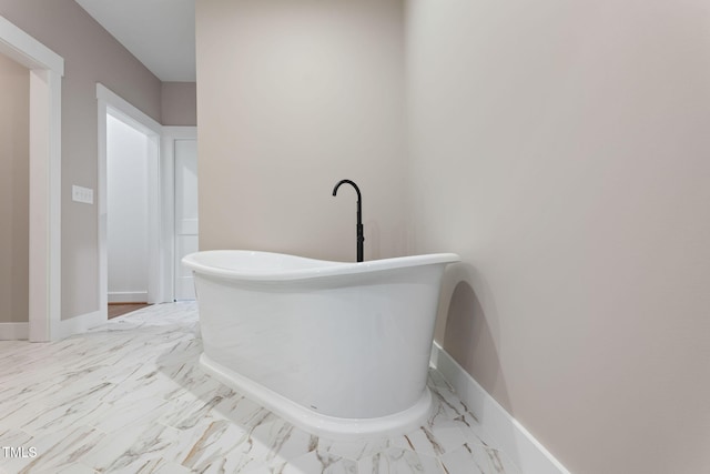 hallway with marble finish floor and baseboards
