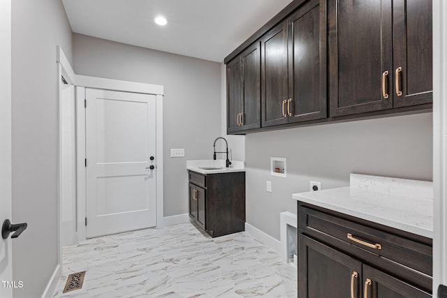 laundry area with a sink, hookup for a washing machine, baseboards, electric dryer hookup, and cabinet space