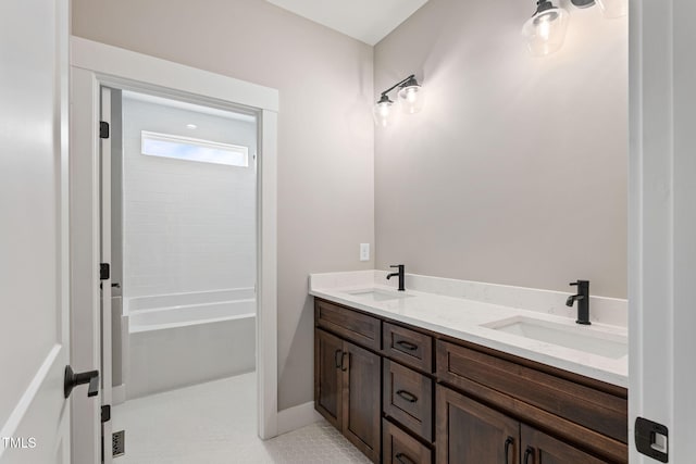 full bathroom featuring double vanity and a sink