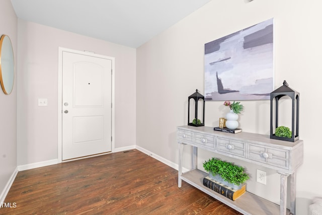 entryway with baseboards, dark wood-style flooring, and visible vents