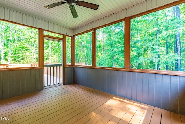 unfurnished sunroom featuring ceiling fan