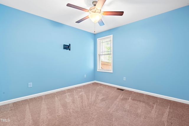 empty room featuring baseboards, visible vents, ceiling fan, and carpet