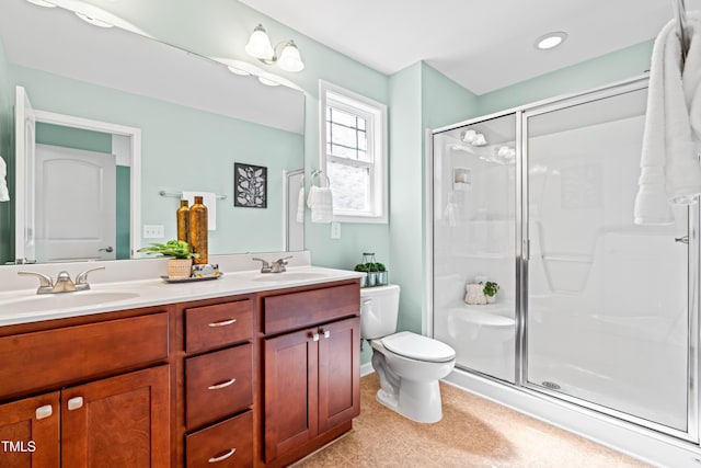 bathroom with double vanity, a sink, and a stall shower