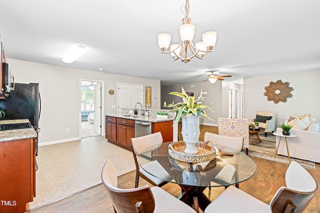 dining room featuring baseboards, ceiling fan with notable chandelier, and light floors