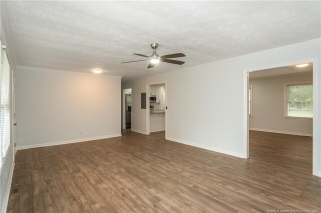 1016 Martindale Dr, Fayetteville, NC 28304 - unfurnished living room featuring ceiling fan, crown molding, wood finished floors, and a textured ceiling