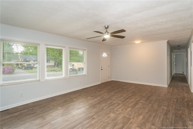 1016 Martindale Dr, Fayetteville, NC 28304 - unfurnished living room with a textured ceiling, baseboards, wood finished floors, ceiling fan, and crown molding