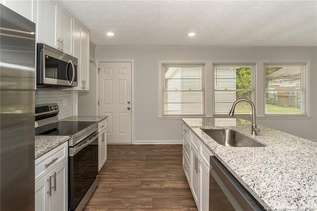 1016 Martindale Dr, Fayetteville, NC 28304 - kitchen with white cabinets, stainless steel appliances, a sink, and dark wood finished floors