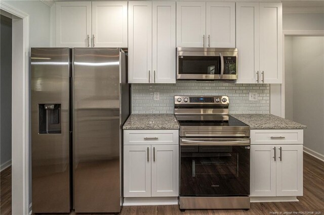 1016 Martindale Dr, Fayetteville, NC 28304 - kitchen featuring light stone countertops, decorative backsplash, dark wood-style floors, and stainless steel appliances