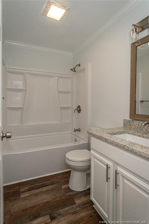 1016 Martindale Dr, Fayetteville, NC 28304 - full bathroom with shower / washtub combination, wood finished floors, toilet, vanity, and crown molding