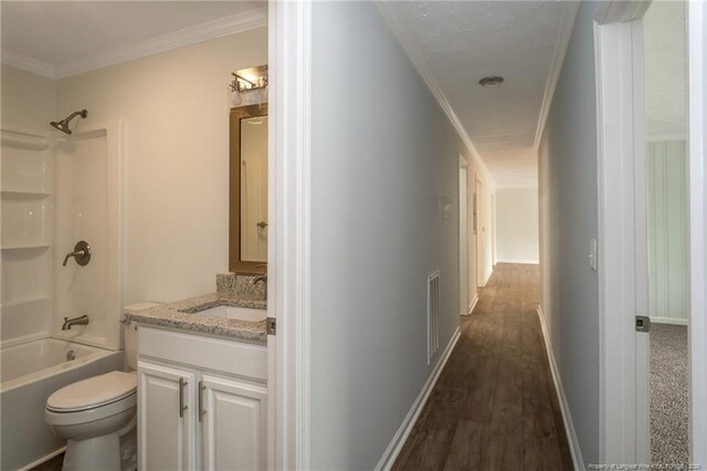 1016 Martindale Dr, Fayetteville, NC 28304 - hallway featuring visible vents, a sink, dark wood-type flooring, crown molding, and baseboards