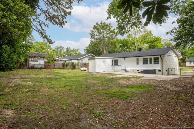 1016 Martindale Dr, Fayetteville, NC 28304 - back of house featuring a lawn, fence, a patio area, and crawl space