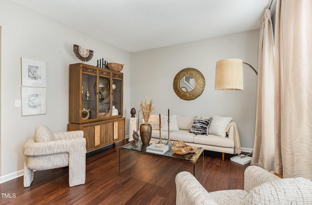 living area featuring baseboards and wood finished floors