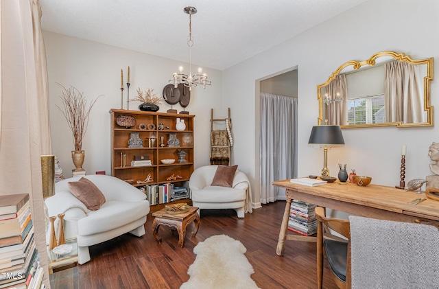 sitting room featuring an inviting chandelier and wood finished floors