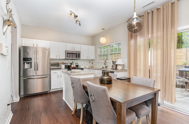 kitchen with visible vents, decorative backsplash, a wealth of natural light, and stainless steel appliances