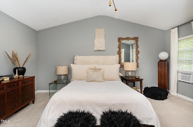 bedroom with lofted ceiling, light carpet, and baseboards
