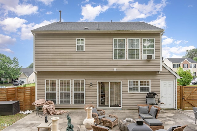 back of property with cooling unit, an outdoor hangout area, a patio area, and fence