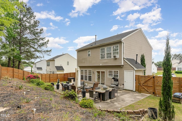 back of property featuring a gate, outdoor lounge area, a patio, and a fenced backyard