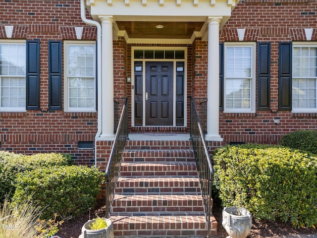 property entrance featuring brick siding