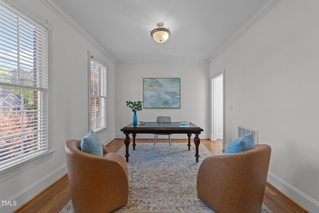 office featuring baseboards, wood finished floors, and ornamental molding