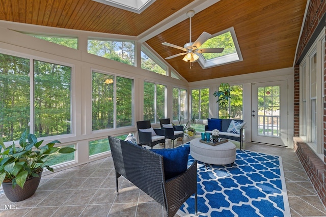 sunroom with a skylight, french doors, and beamed ceiling