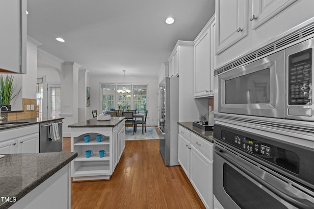 kitchen featuring a chandelier, white cabinetry, open shelves, and stainless steel appliances