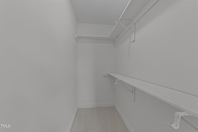spacious closet featuring light tile patterned flooring