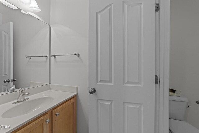 bathroom with toilet and vanity