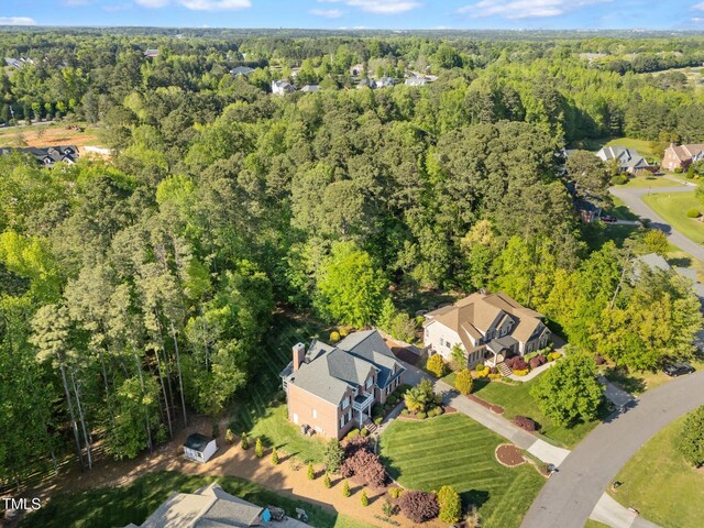 aerial view featuring a forest view and a residential view