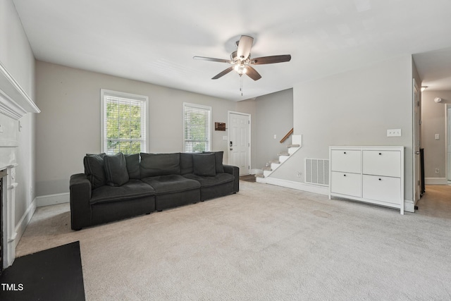 2028 Ruddy Rd, Raleigh, NC 27616 - carpeted living area with a fireplace, stairs, visible vents, a ceiling fan, and baseboards